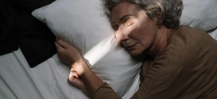 Older woman sleeping peacefully in bed